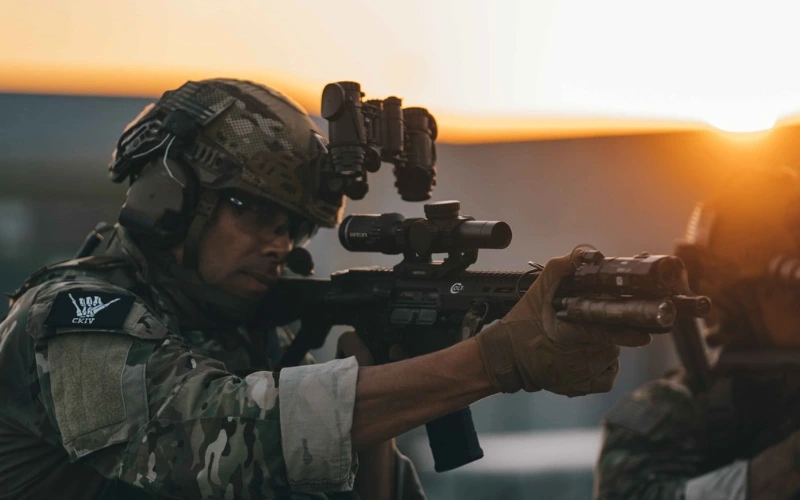 Operator at sunset with a helmet mounted optic and rifle scope. | Chase Tactical | Tactical Gear Operator At Sunset With A Helmet Mounted Optic And Rifle Scope.