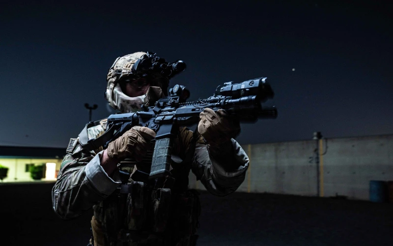 Tactical team members with helmet mounted optics aiming at dusk during a field exercise. | Chase Tactical | Tactical Gear Tactical Team Members With Helmet Mounted Optics Aiming At Dusk During A Field Exercise.