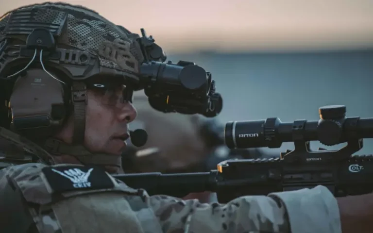 Soldier wearing a tactical headset with boom mic while aiming a rifle | Chase Tactical | Tactical Gear Soldier Wearing A Tactical Headset With Boom Mic While Aiming A Rifle